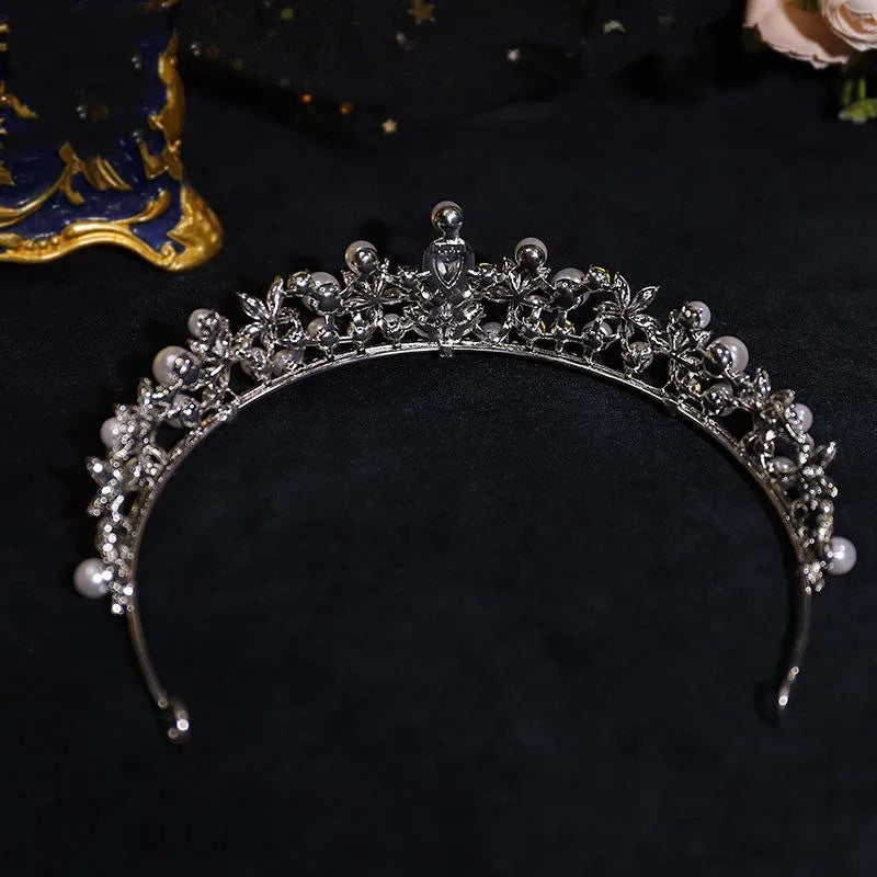 Silver pearl and rhinestone bridal crown tiara with ornate floral center, curved band