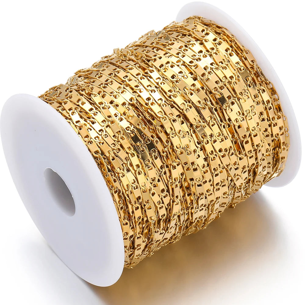 Gold stainless steel flat link chain on a white spool for DIY jewelry making