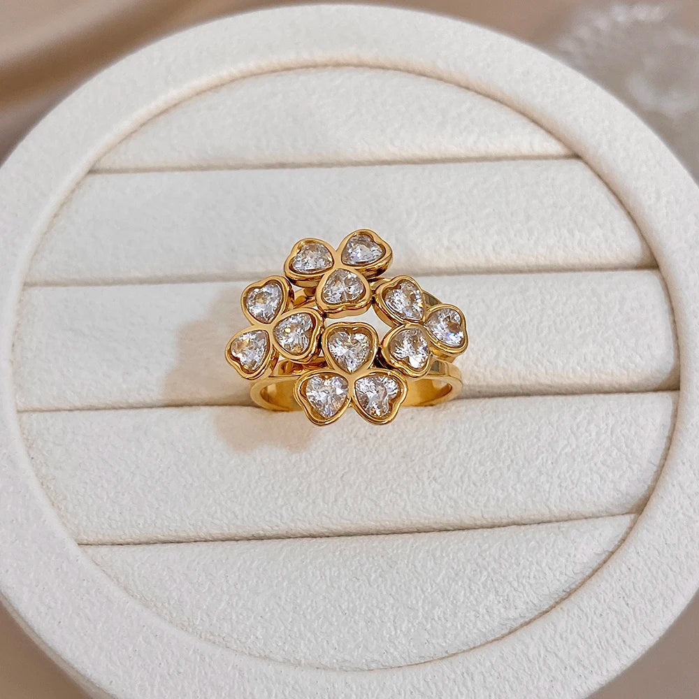 Gold-tone flower cluster ring with clear round stones and open center