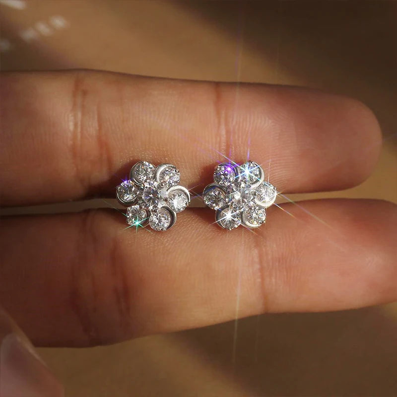 Flower-shaped cubic zirconia stud earrings with sparkle, round stone clusters, silver-tone