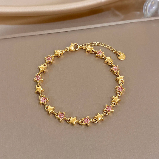 Gold-tone star charm bracelet with multicolor zircon-like inlays, round link chain