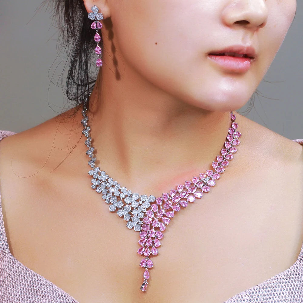 Pink and clear cubic zirconia bridal necklace and drop earring worn by a model