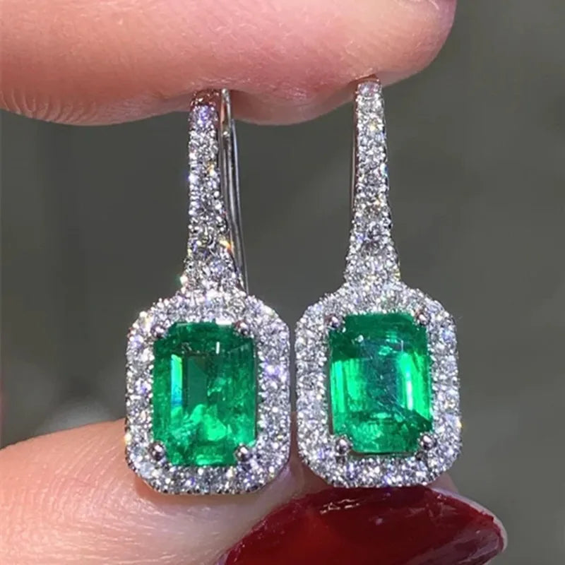 Silver-tone green cubic zirconia dangle earrings with rectangular halo stones