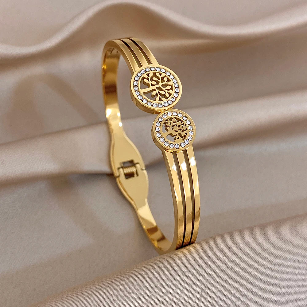 Gold-tone stackable cuff bracelets with two round zircon medallions and ridged bands