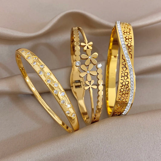 Gold plated cuff bangle set with daisy flower motifs and small clear stones