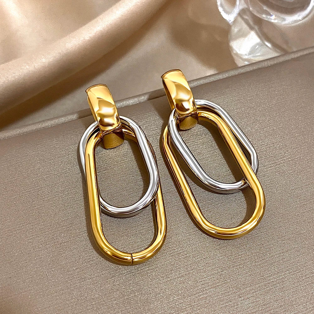 Gold and silver oval-link earrings shown from the front
