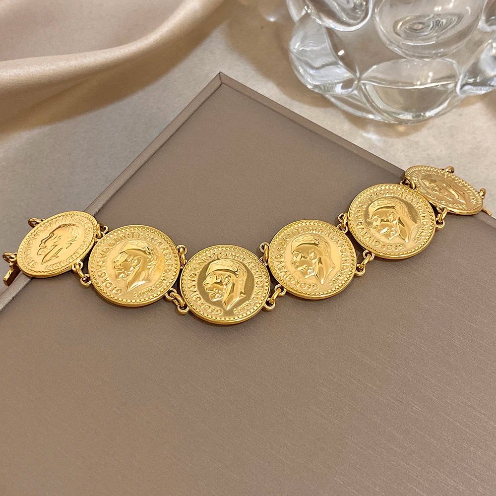 Gold coin charm bracelet with round medallion links
