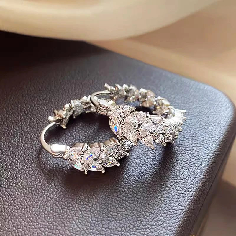 Silver cubic zirconia marquise hoop earrings with clustered stones, sparkly oval setting