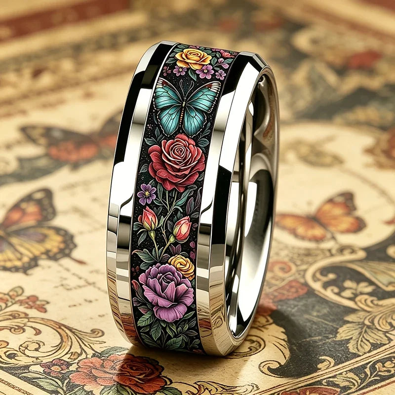 Angled view of floral butterfly stainless steel ring, black band with gold inner