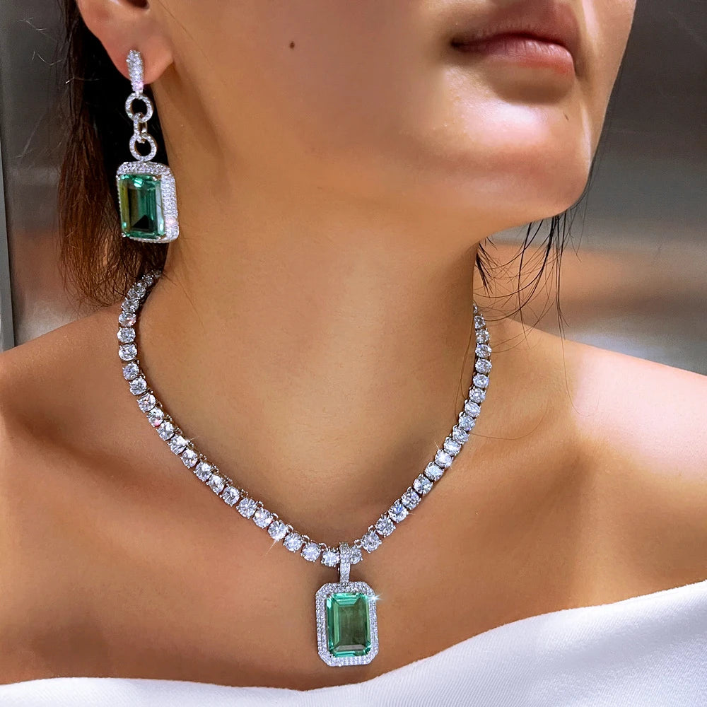 Silver-tone necklace and drop earrings with rectangular teal cubic zirconia stones