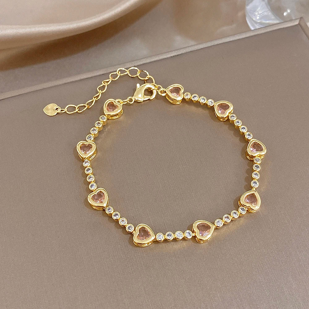 Gold-plated bracelet with heart-shaped zircon stones and round crystal accents