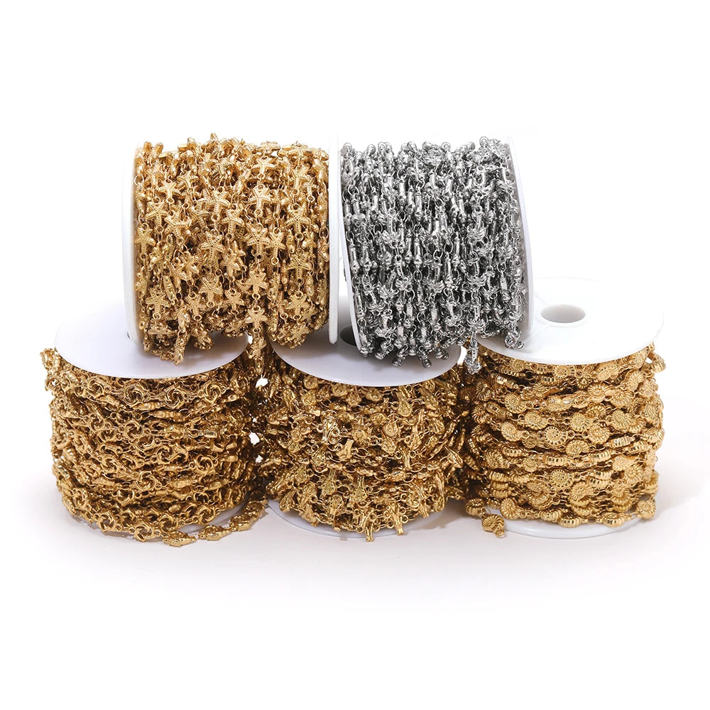 Gold and silver sea-animal charm chain rolls on spools for DIY bracelets and necklaces