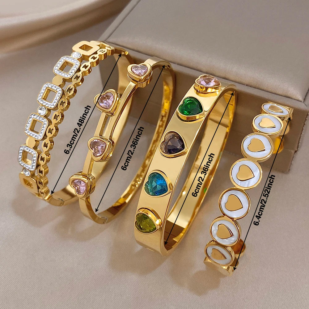 Stacked gold-plated cuff bangles with heart zircon stones and multicolor accents