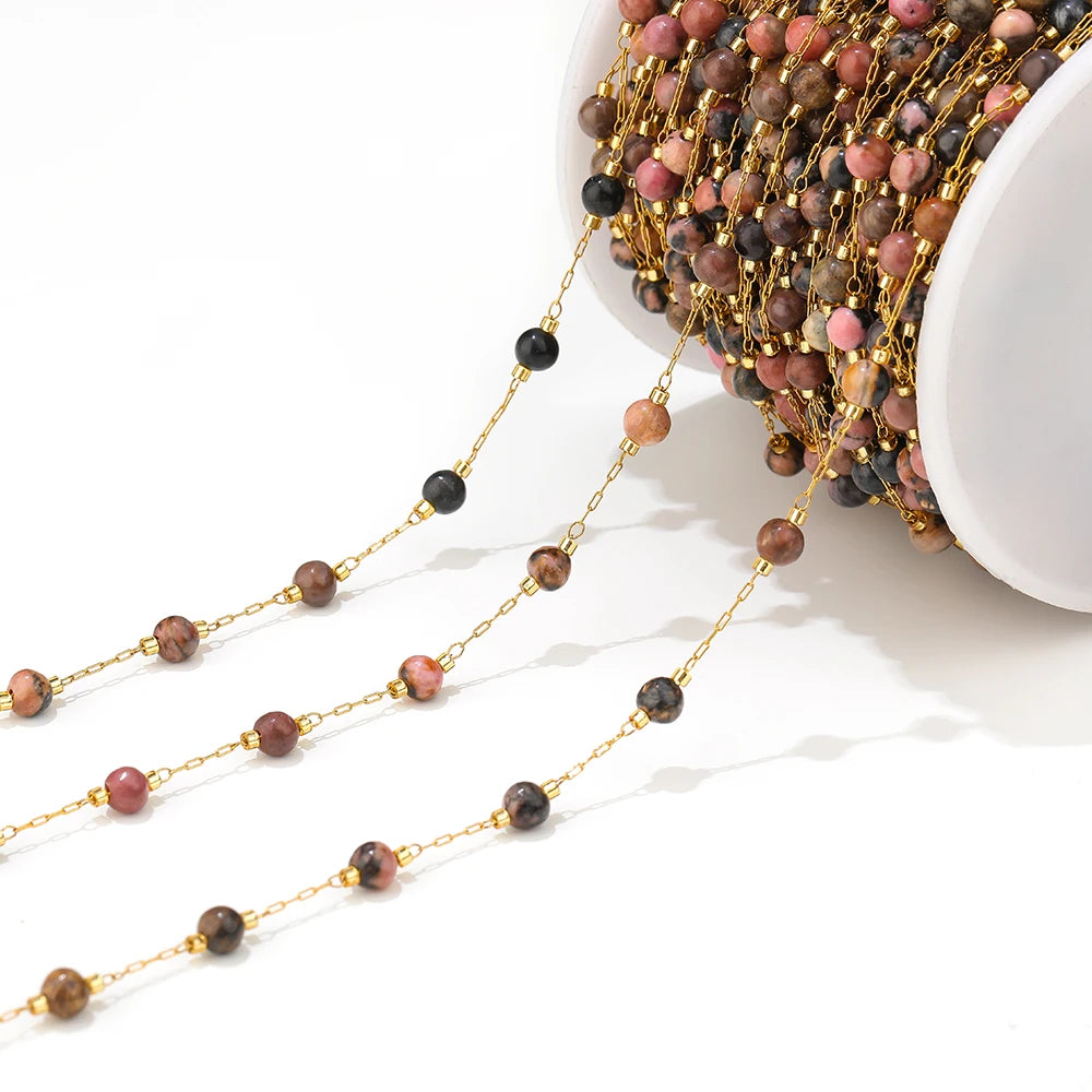 Gold-link gemstone bead chain strand with dark beads, pink, and brown stones