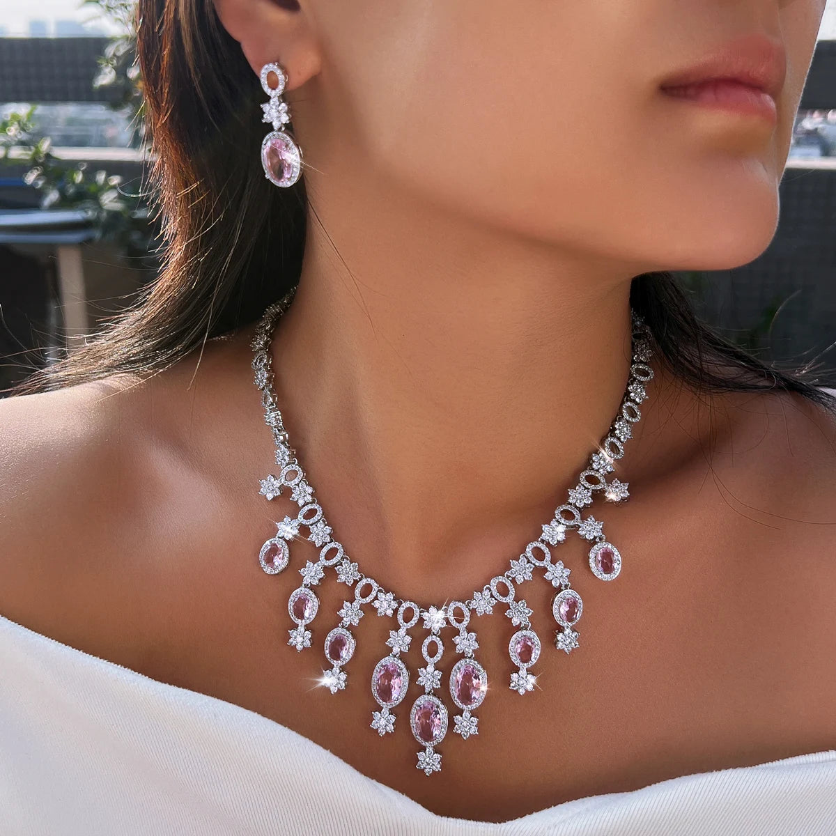 Silver-tone floral necklace with dangling pink oval stones and a matching drop earring