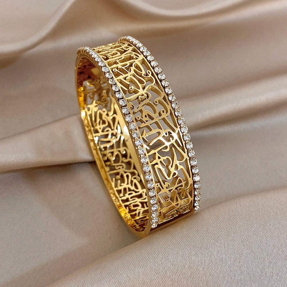 Gold-tone chunky cuff bracelet with hollow geometric lattice and rhinestone border