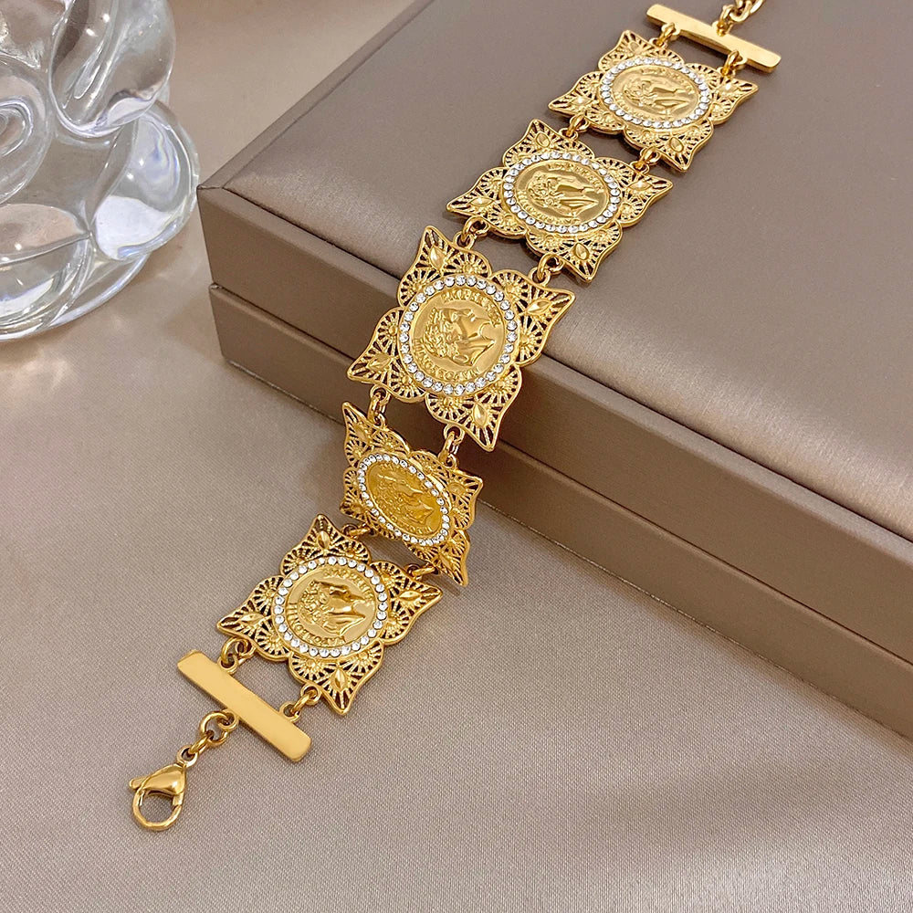 Gold-tone coin bracelet with rhinestone starburst frames and bar clasp, chain links