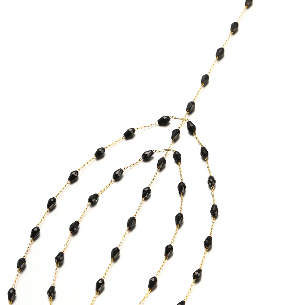 Long strand of black oval crystal beads with gold-tone link chain for necklace