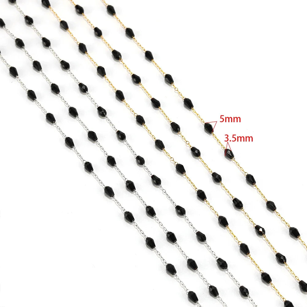 Close-up of black oval crystal bead chain with gold-tone and silver-tone links