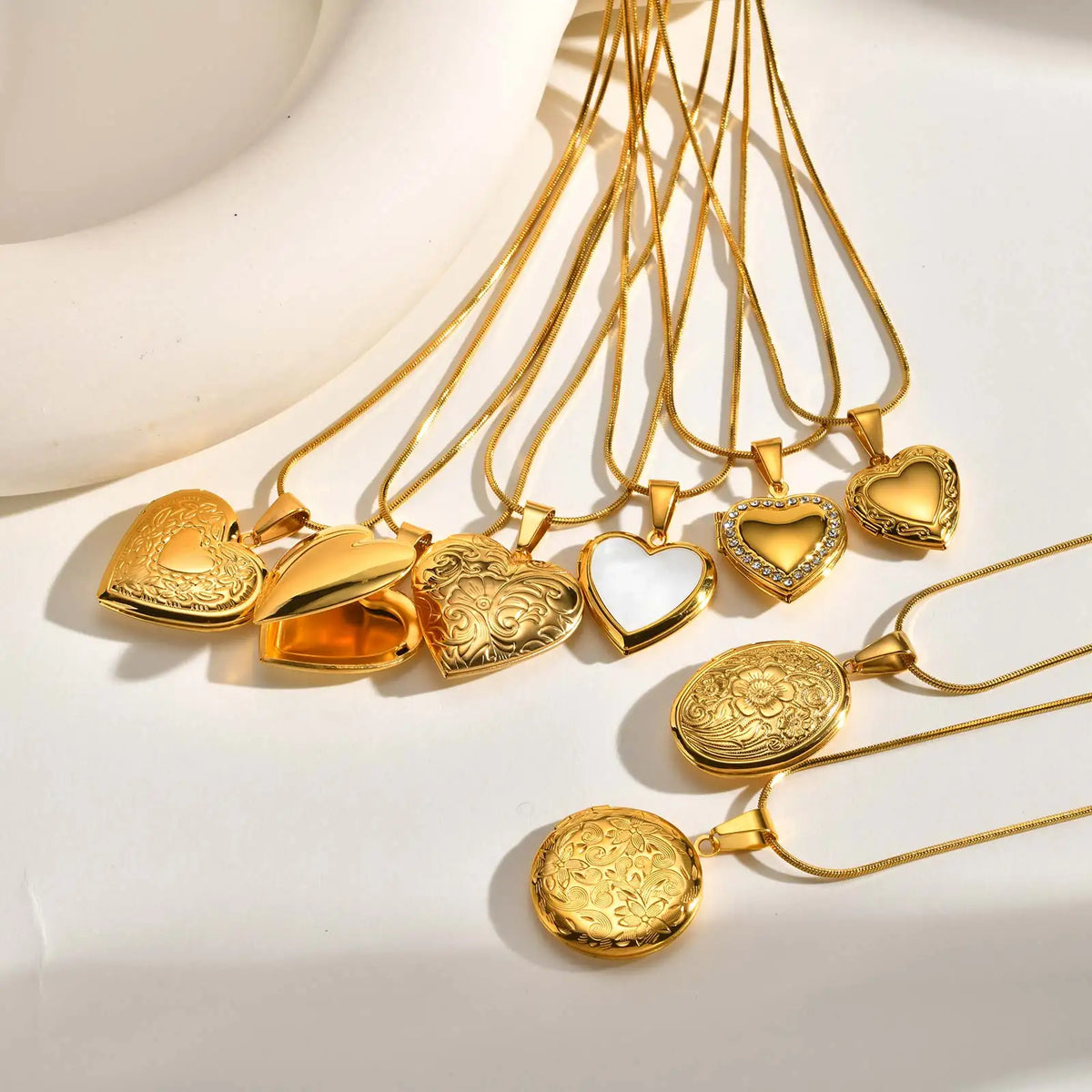 Gold heart pendant necklace with multiple ornate heart charms on thin chains