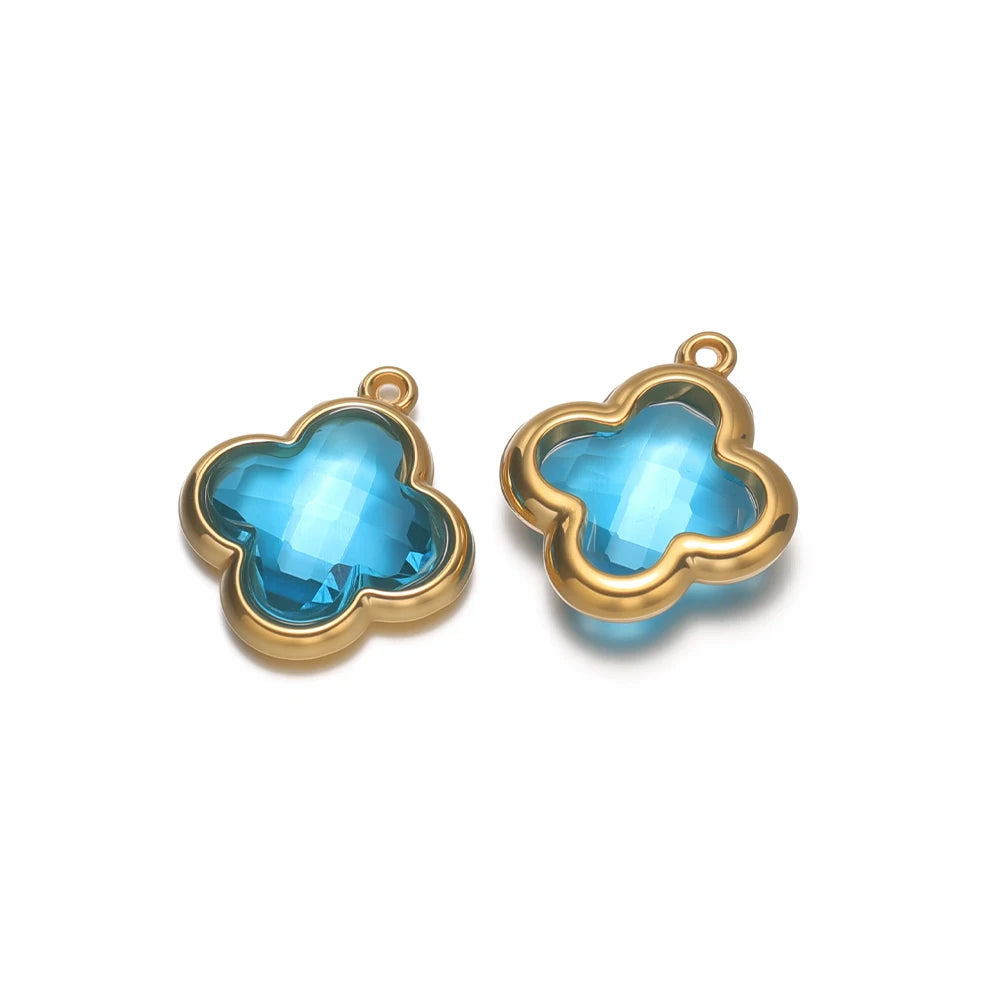 Four-leaf clover glass charm pendant with light blue gem and gold-tone loop