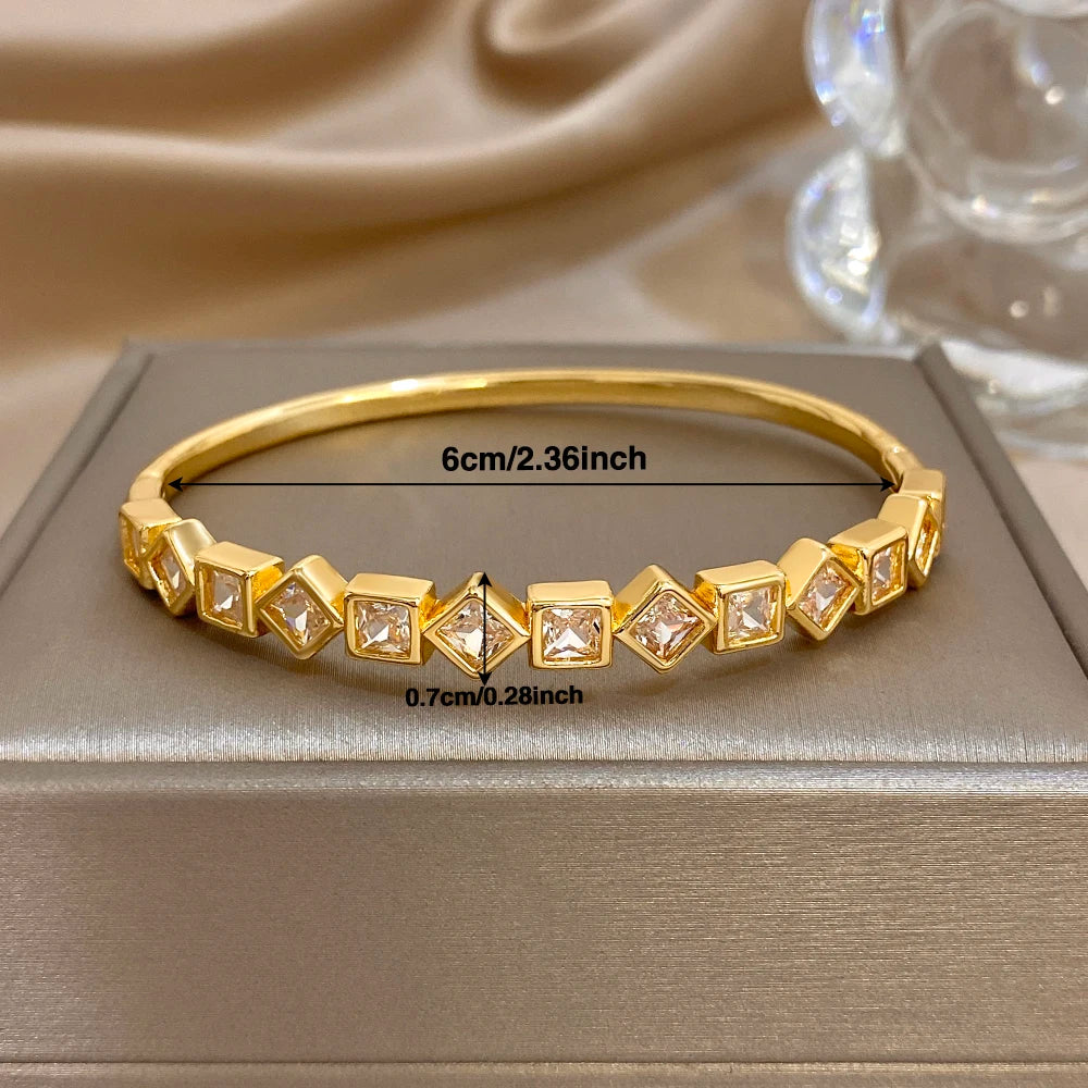 Gold-tone zircon cuff bracelet size shown: slim curved band with square clear stones