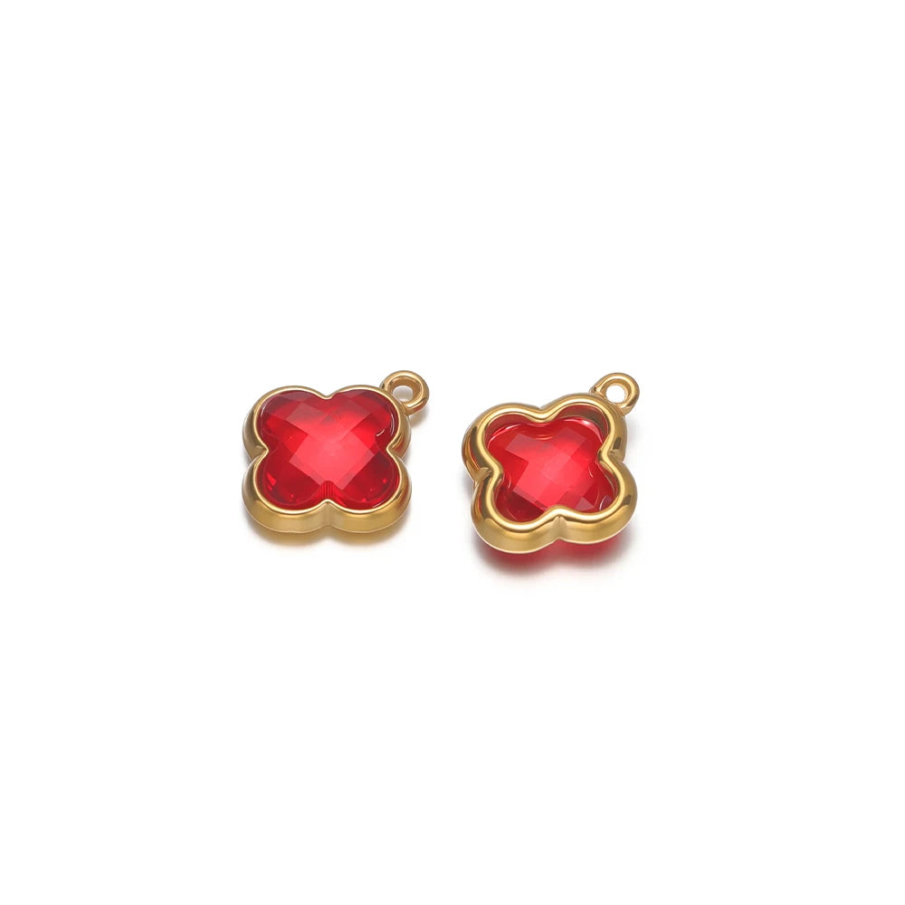 Four-leaf clover glass charm pendant with red gem and gold-tone loop