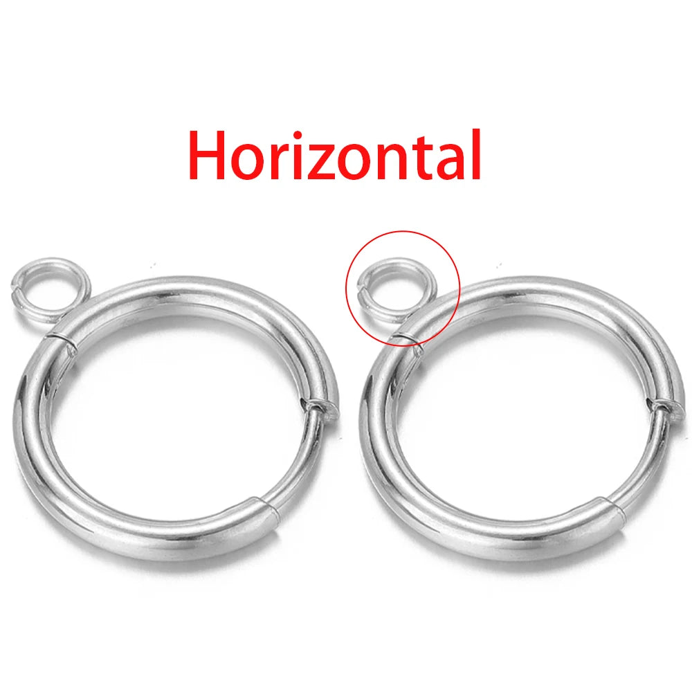Silver-tone huggie hoops showing horizontal loop post placement on the ring.