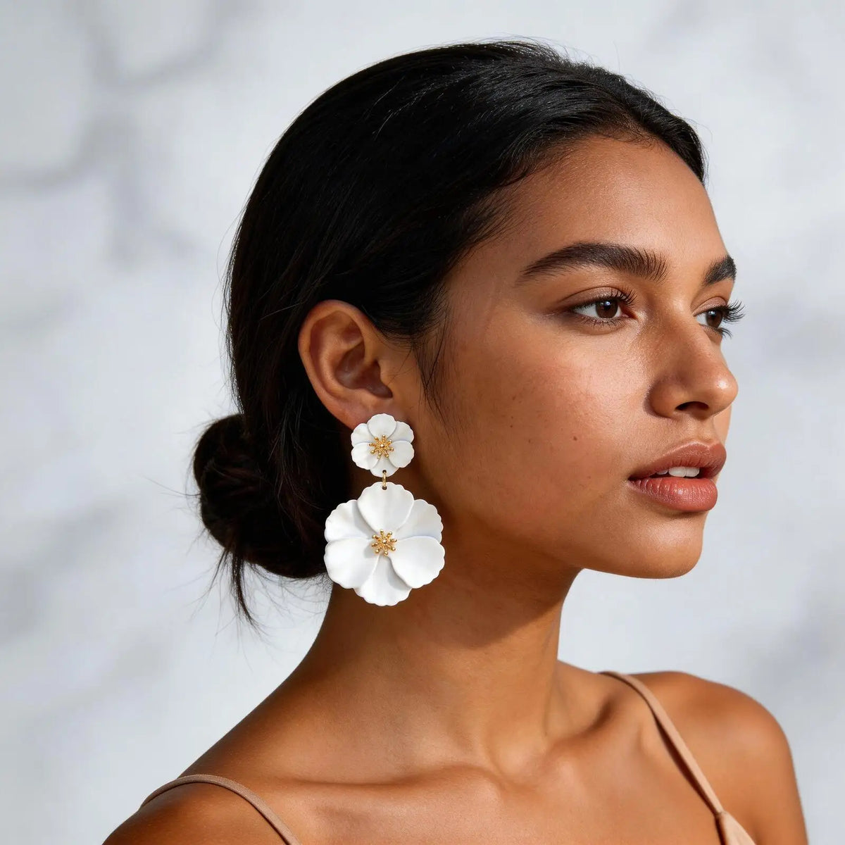 White double floral drop earrings with gold-tone detail