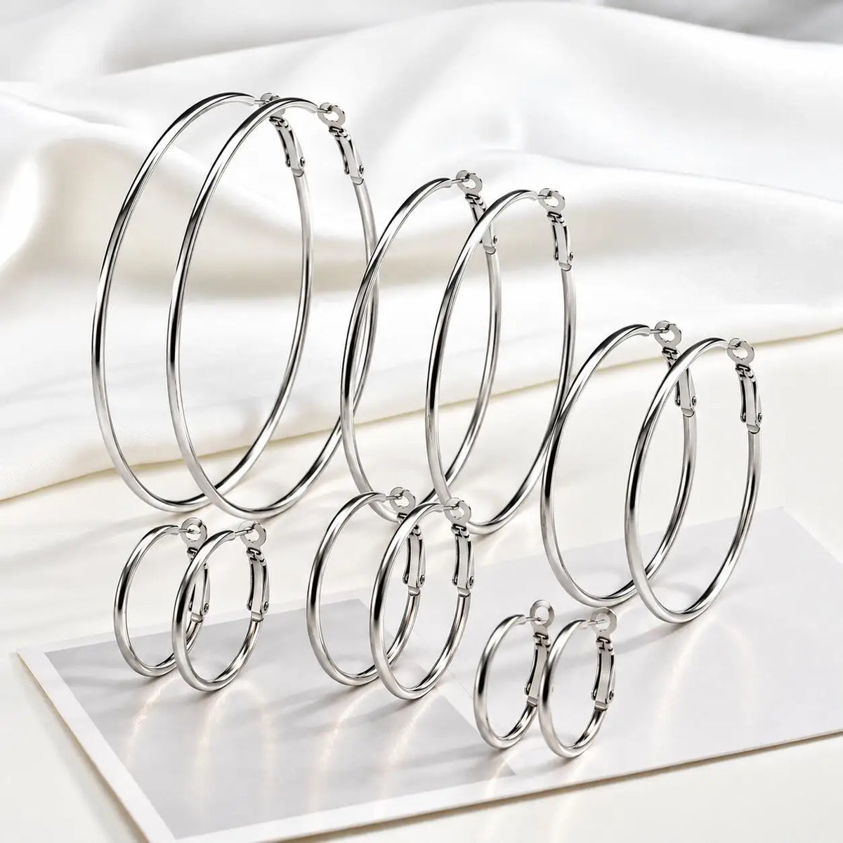 Silver-tone stainless steel hoop earrings in six sizes, from small to oversized.
