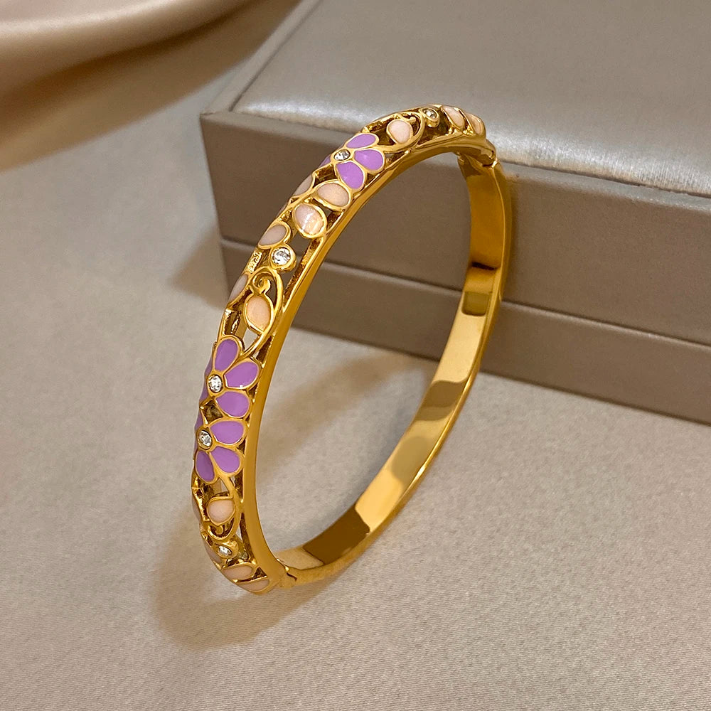 Gold-plated cuff bangle with purple enamel flower pattern and white enamel sections