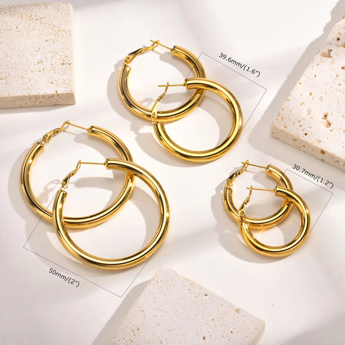 Gold chunky hoop earrings shown in 30.7, 39.6, and 50 mm sizes