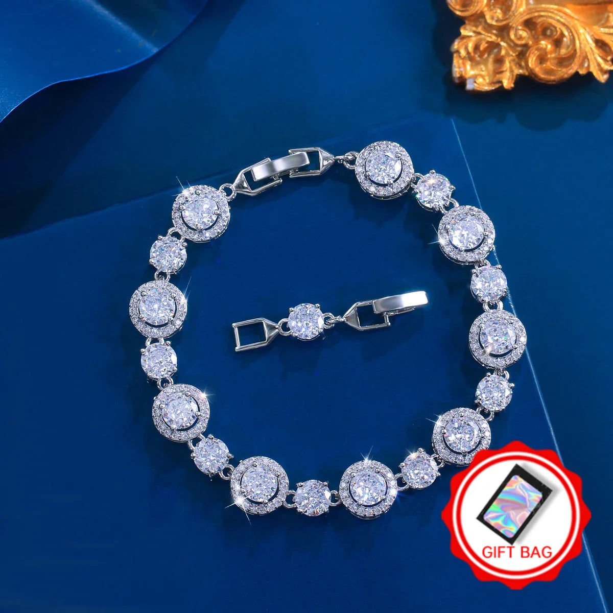 Silver-tone tennis bracelet with round clear stones and a gift bag