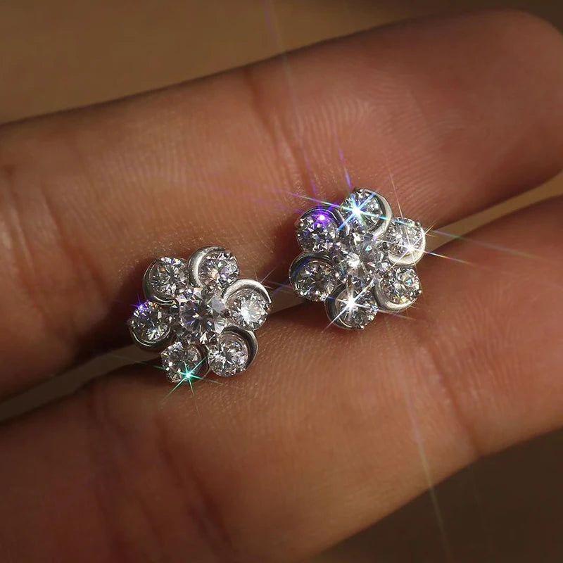 Flower-shaped cubic zirconia stud earrings, clustered round stones, silver-tone pair