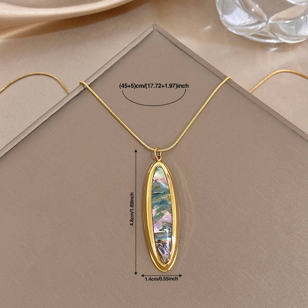 Gold oval abalone pendant necklace with thin snake chain and polished bezel