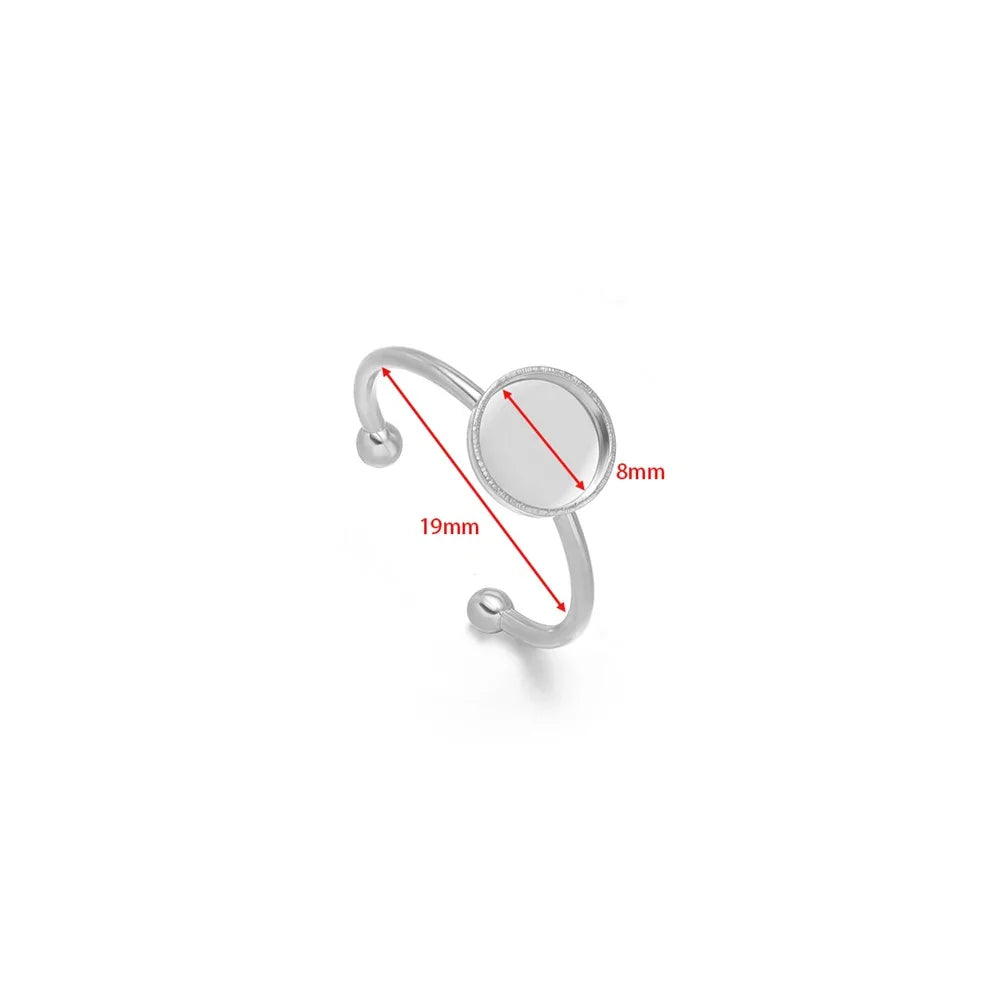 Silver open cabochon ring setting with oval-profile band and round blank tray