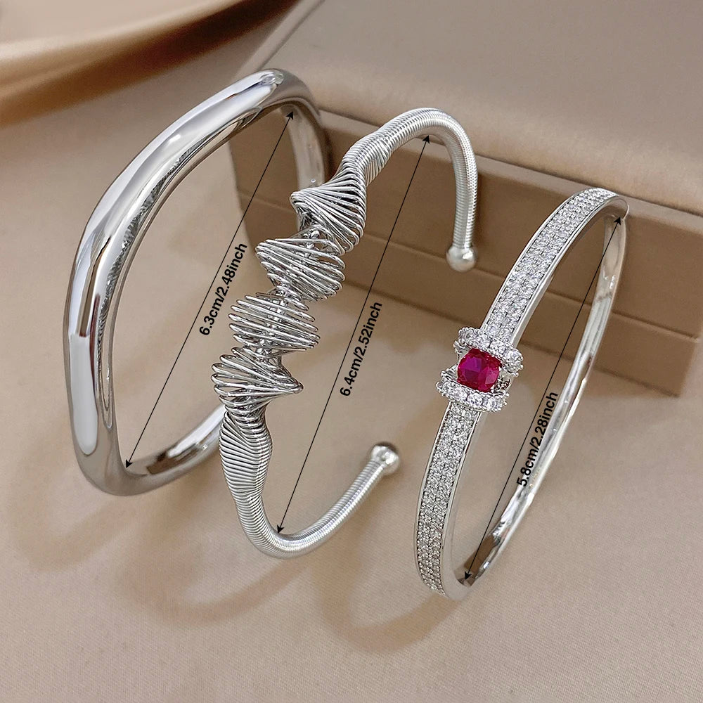 Silver cuff bracelets with textured wave band and rectangular red gemstone centerpiece
