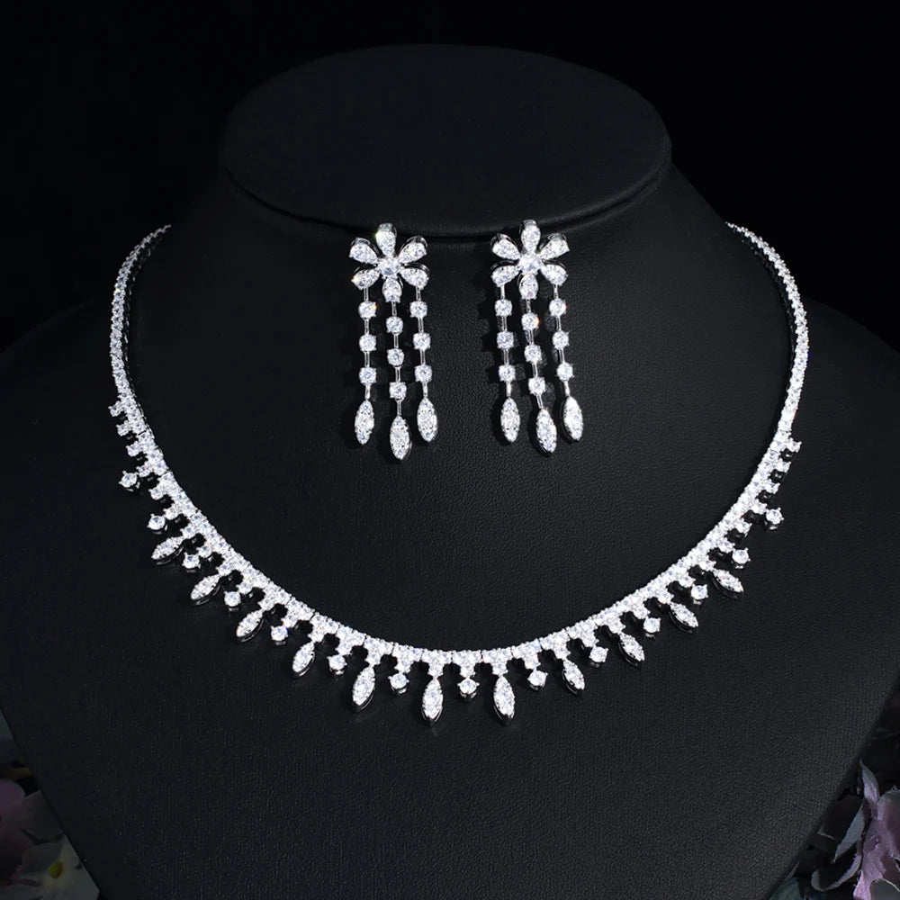Cubic zirconia choker necklace with matching dangling earrings on dark display bust