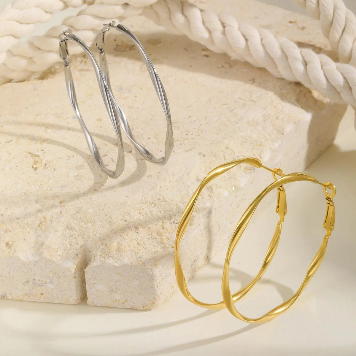 Twisted hoop earrings in silver and gold tones