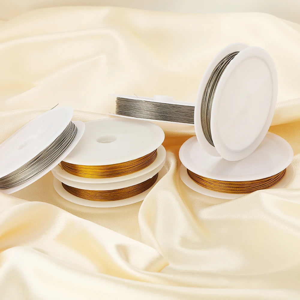 Stainless steel beading wire cords on white spools in gold and steel
