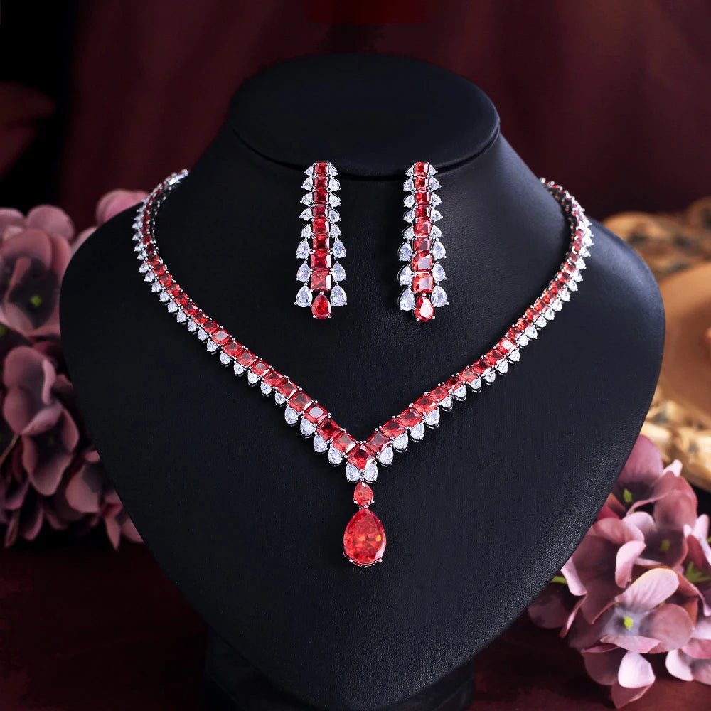 Red cubic zirconia necklace and drop earrings set with a V-shaped chain and teardrop pendant