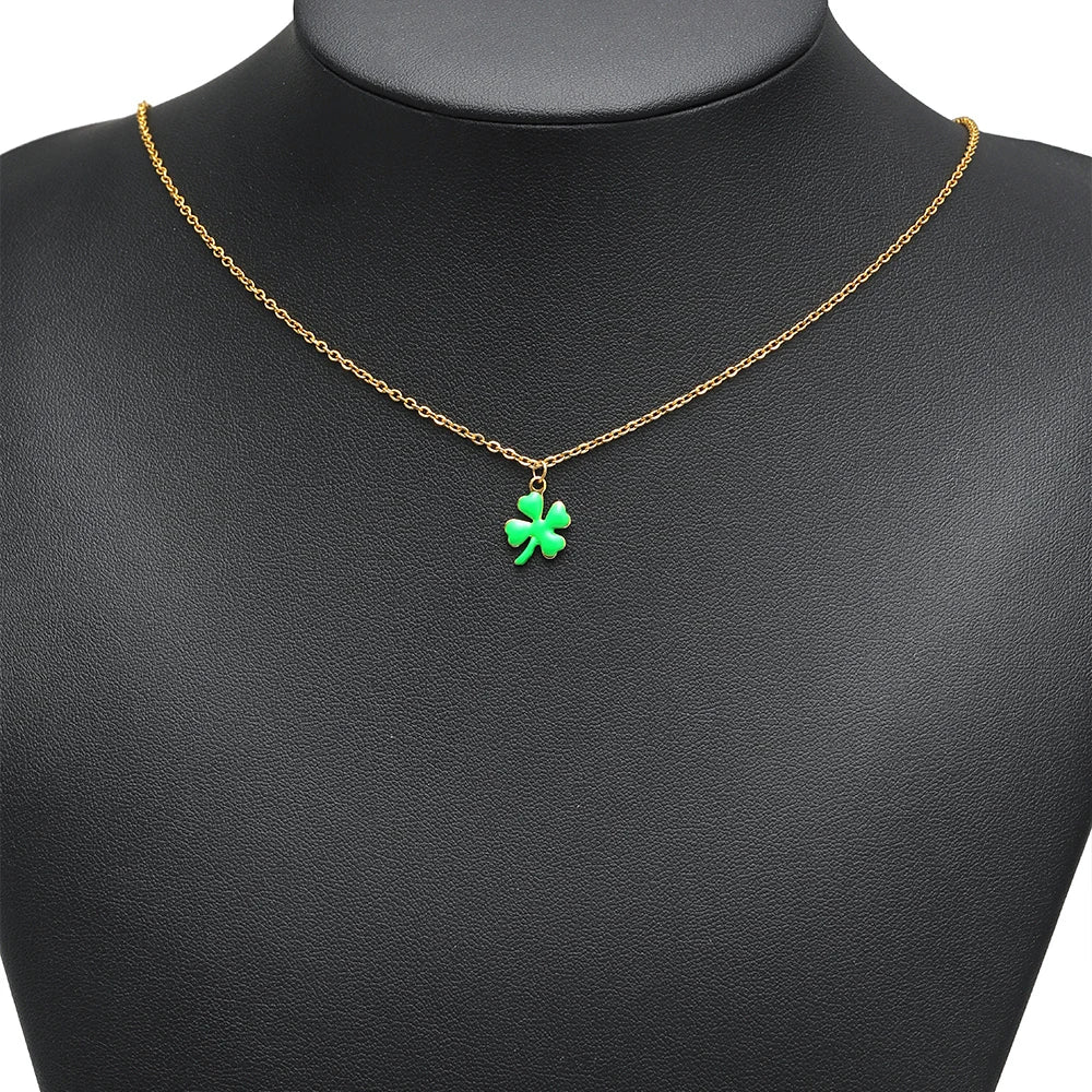 Green enamel clover charm pendant on a gold-tone chain necklace