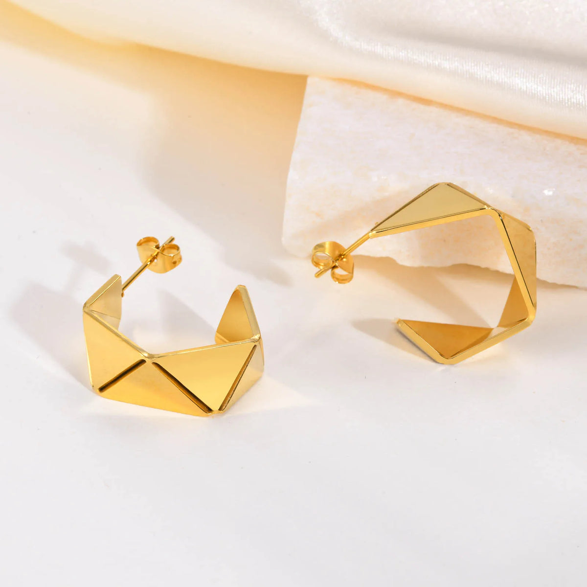 Geometric gold-plated hoop earrings with faceted open cube design