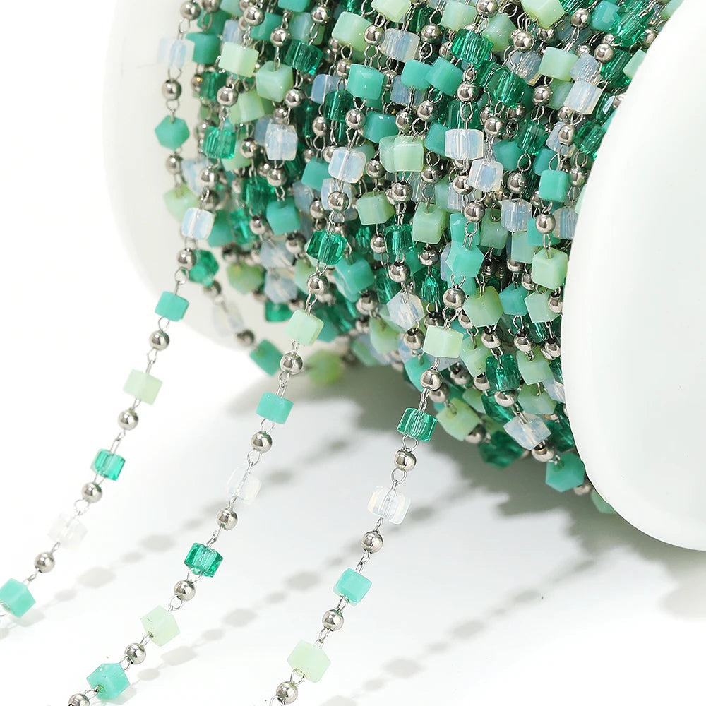 Close-up irregular glass bead link chain with mint and white beads on silver-tone links