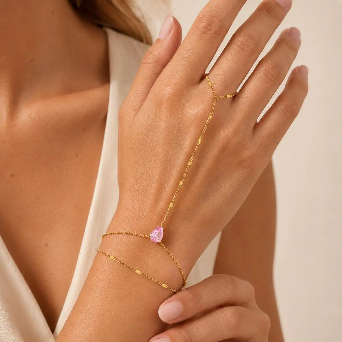 Gold-tone heart CZ hand chain bracelet with pink heart charm