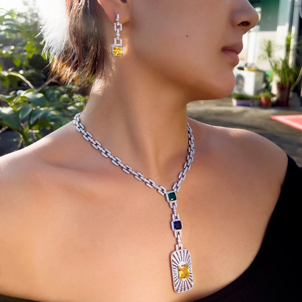 Zirconia cuban link necklace set on model with yellow heart pendant and blue square links
