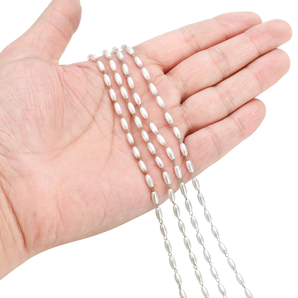Pearl bead chain strand in hand, white oval beads with silver-tone links