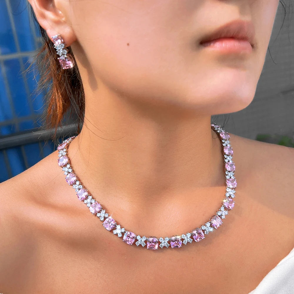 Pink square zirconia tennis-style necklace with matching square drop earrings on model