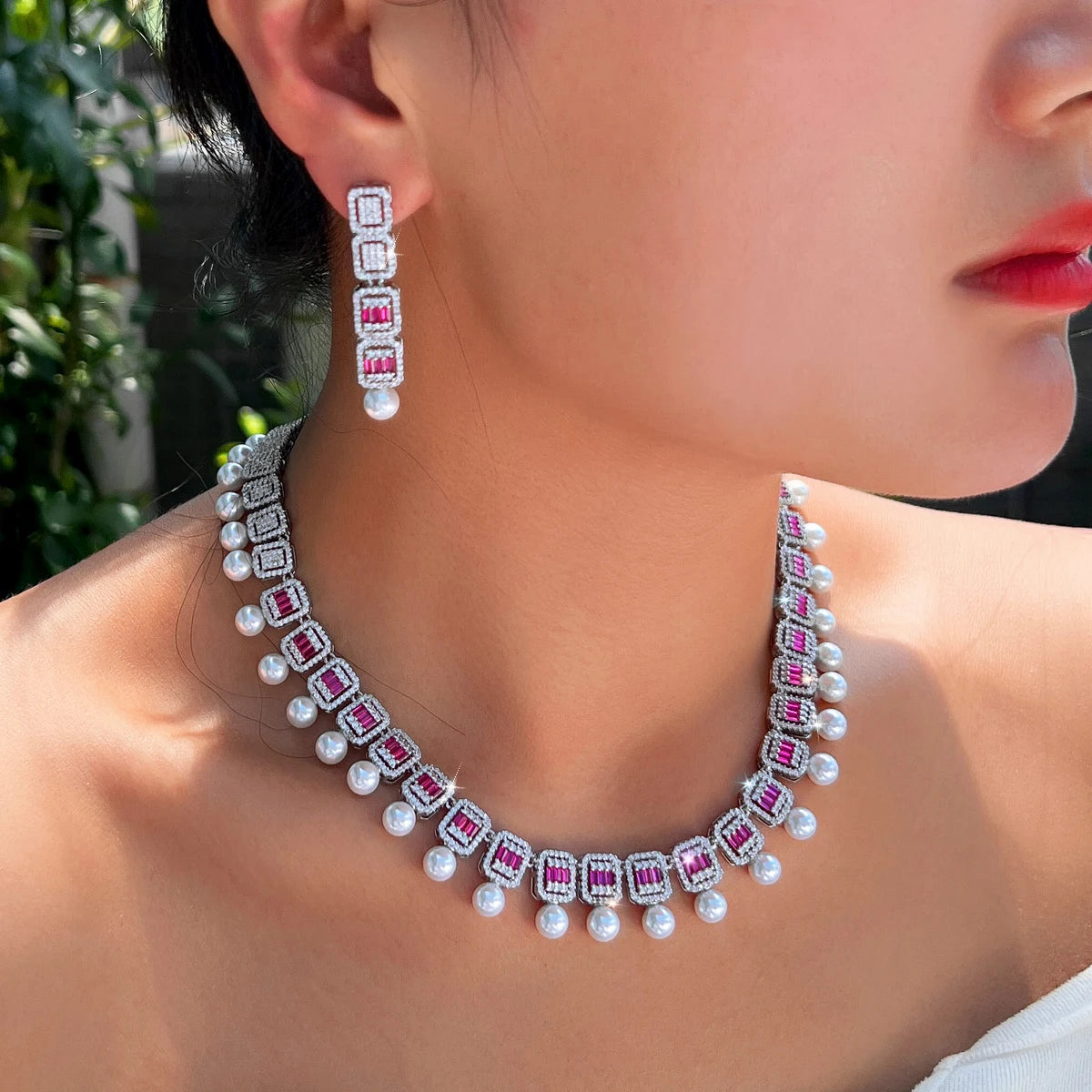 Geometric CZ jewelry set featuring a pearl bead necklace with rose details and dangling earrings