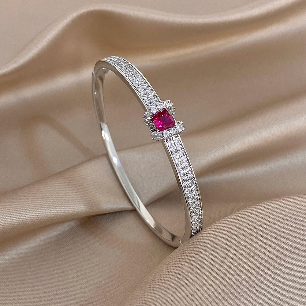 Silver zircon cuff bangle with pink round center stone and crystal pave border
